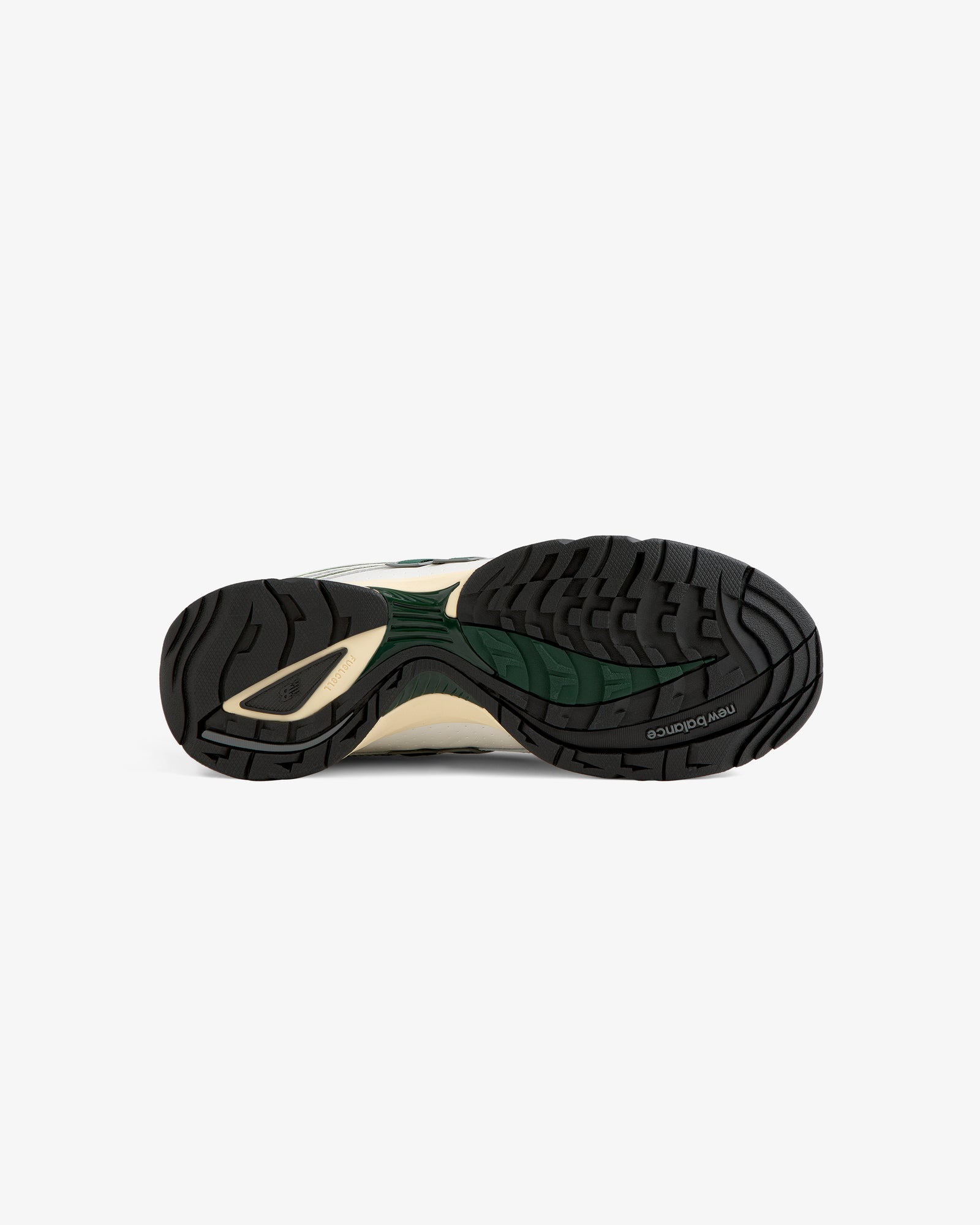 Bottom view of the ALD / New Balance RC56 sneaker showing a black, green, and beige rubber sole with patterned tread.