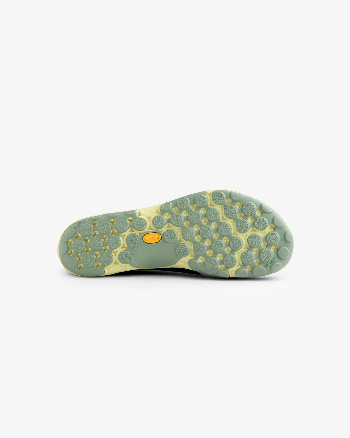 Light green sole of the ALD / New Balance MT10T Sport Shoe with hexagonal, circular tread and yellow Vibram logo.