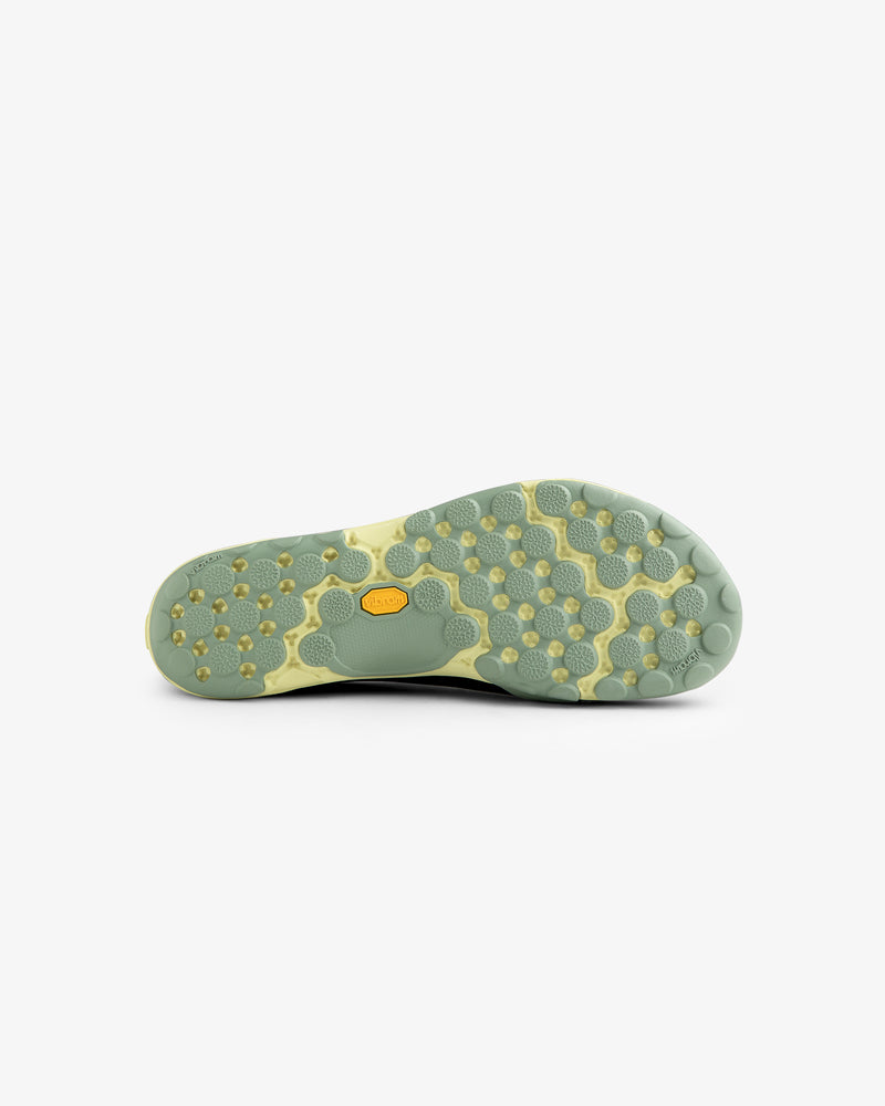 Light green sole of the ALD / New Balance MT10T Sport Shoe with hexagonal, circular tread and yellow Vibram logo.