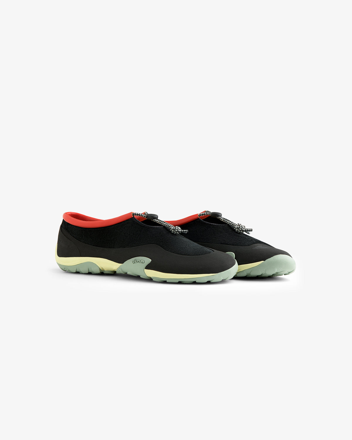 The ALD / New Balance MT10T Sport Shoe: black slip-ons with pale green soles, coral lining, and patterned pull tabs.