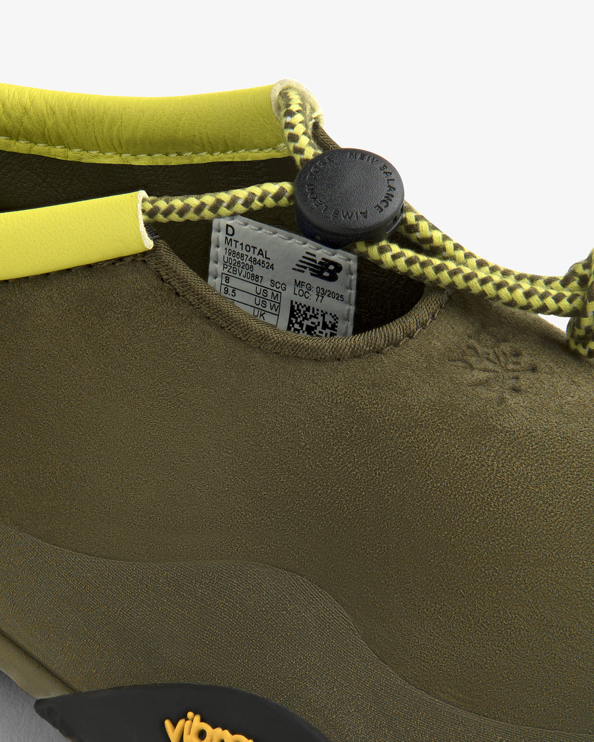 Close-up of the ALD / New Balance MT10T Sport Shoe in olive green with yellow lace, black toggle, and NB label inside.