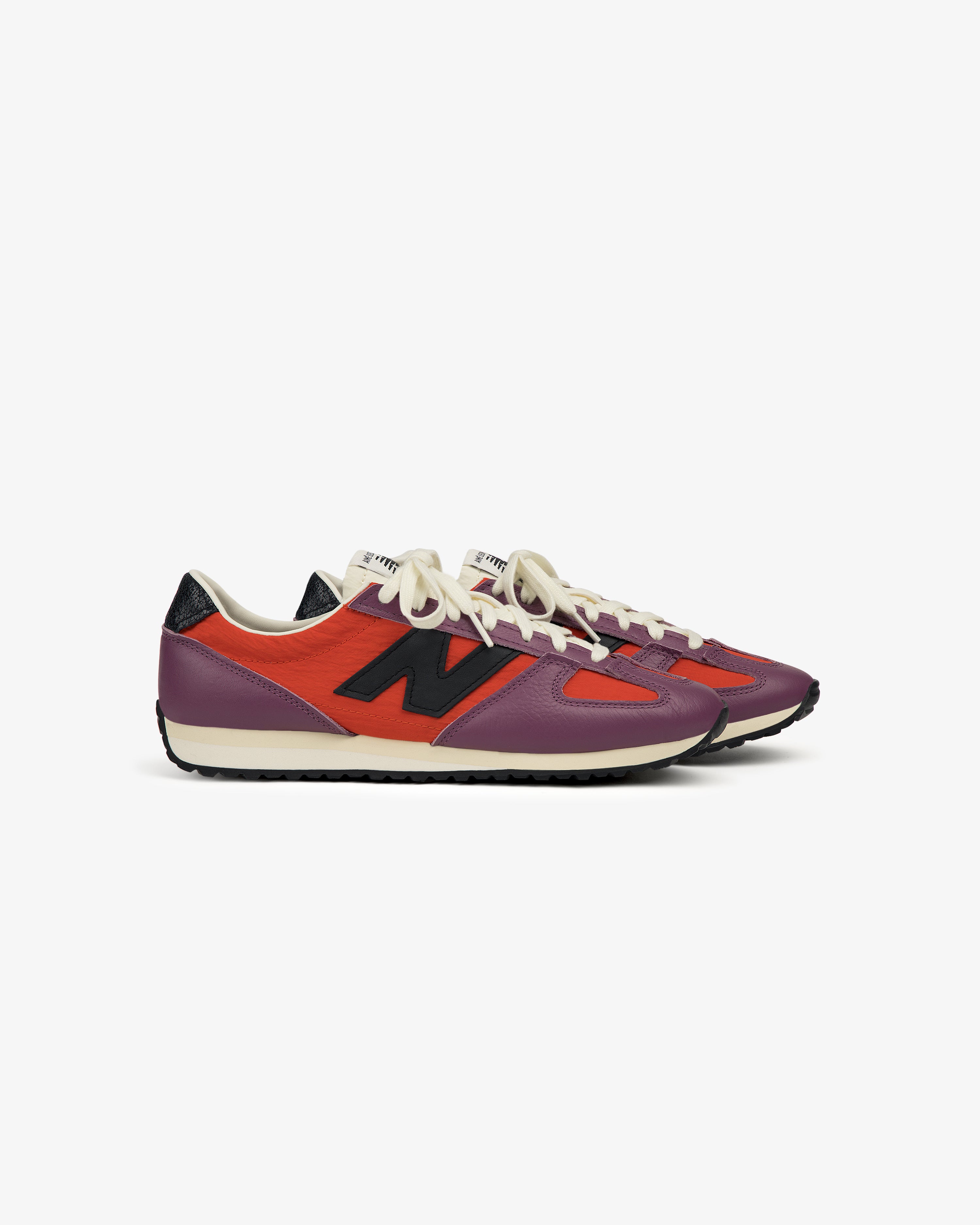 ALD / New Balance 471 sneakers in purple and red with black N logos and white laces on a white background.