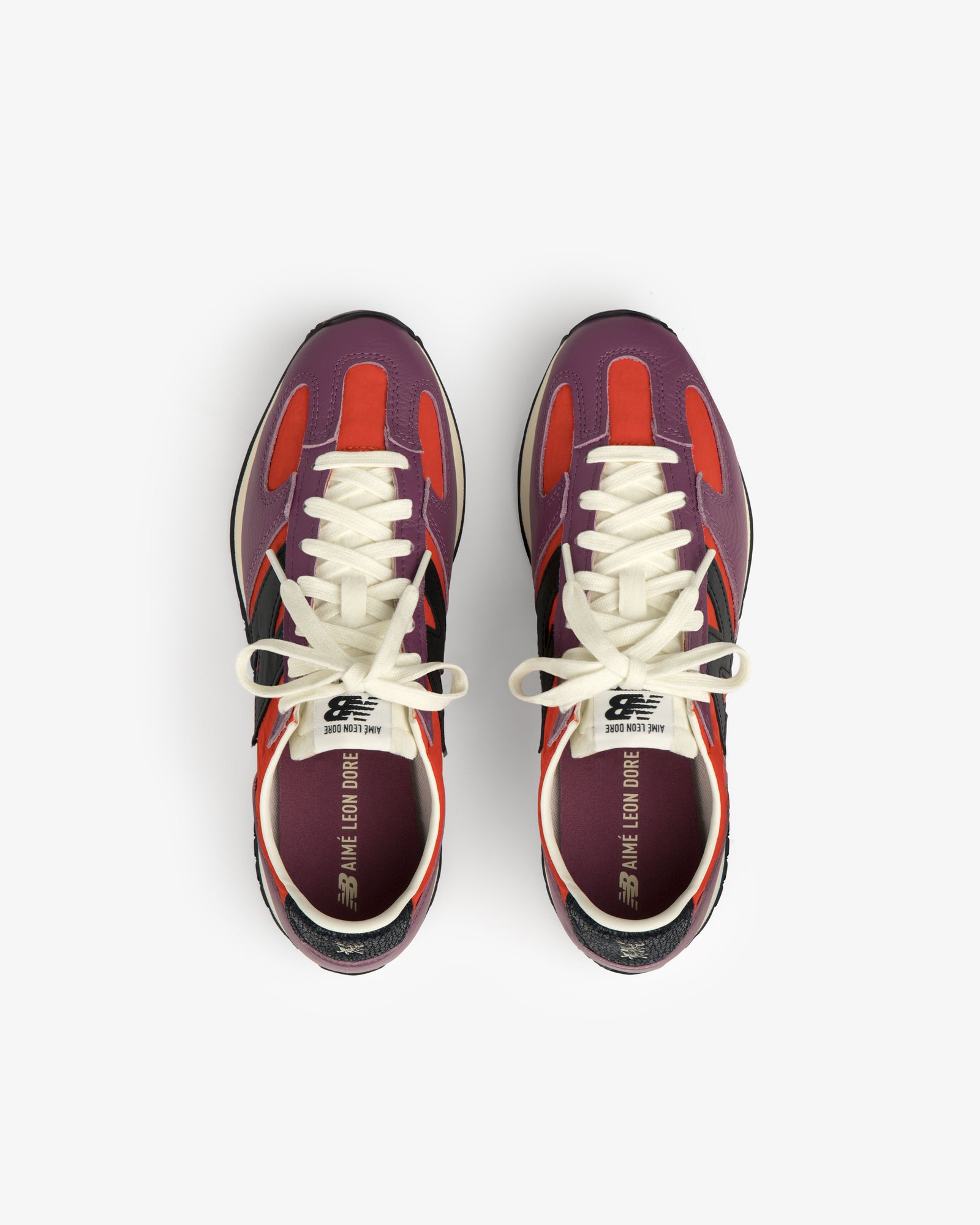 A pair of ALD / New Balance 471 sneakers in red, purple, and black with white laces, viewed from above.