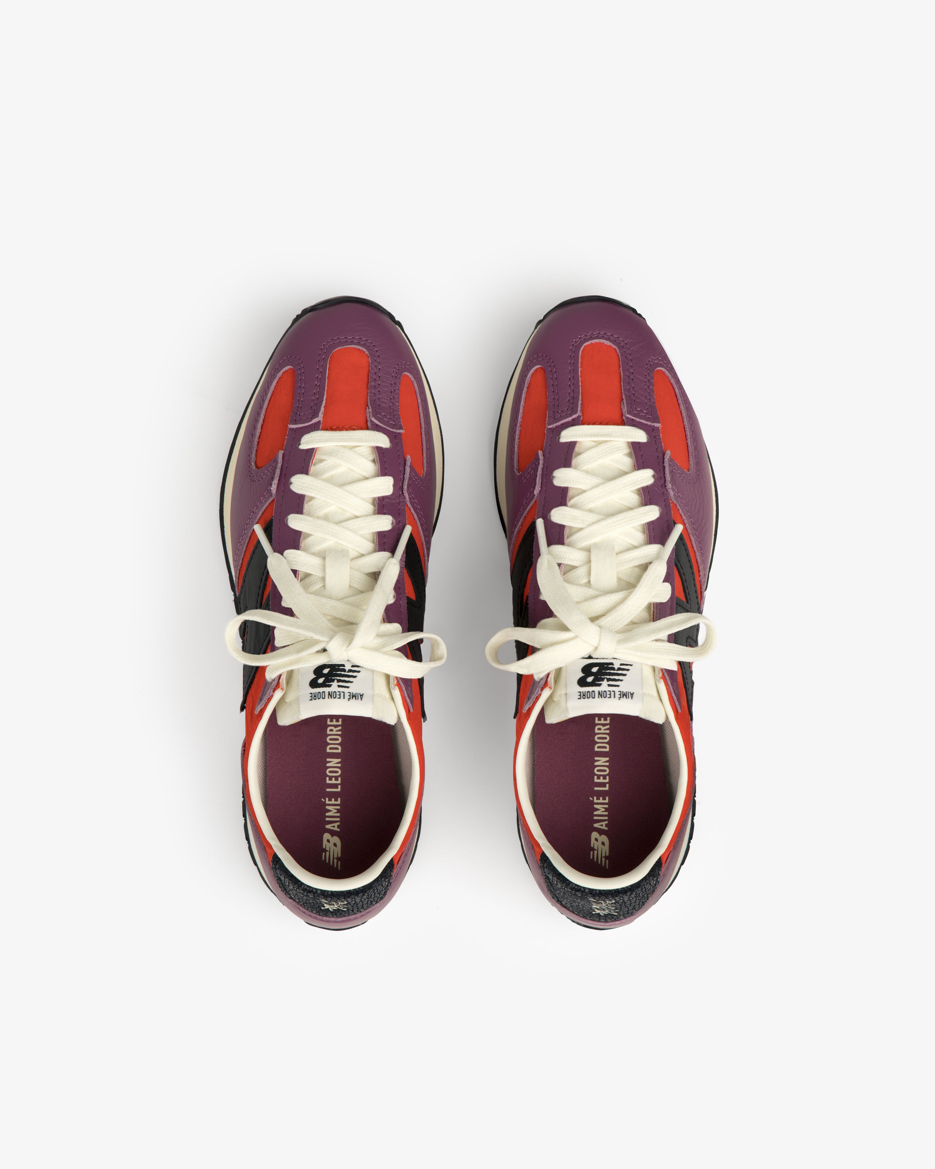A pair of ALD / New Balance 471 sneakers in red, purple, and black with white laces, viewed from above.