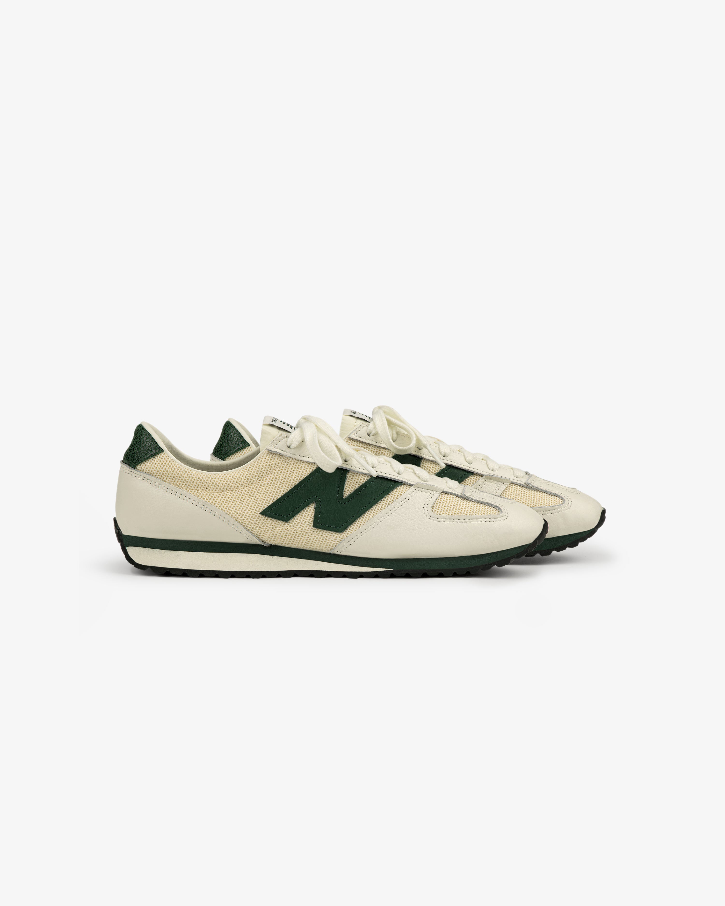 The ALD / New Balance 471 cream sneakers feature dark green accents and laces, shown side view on white.