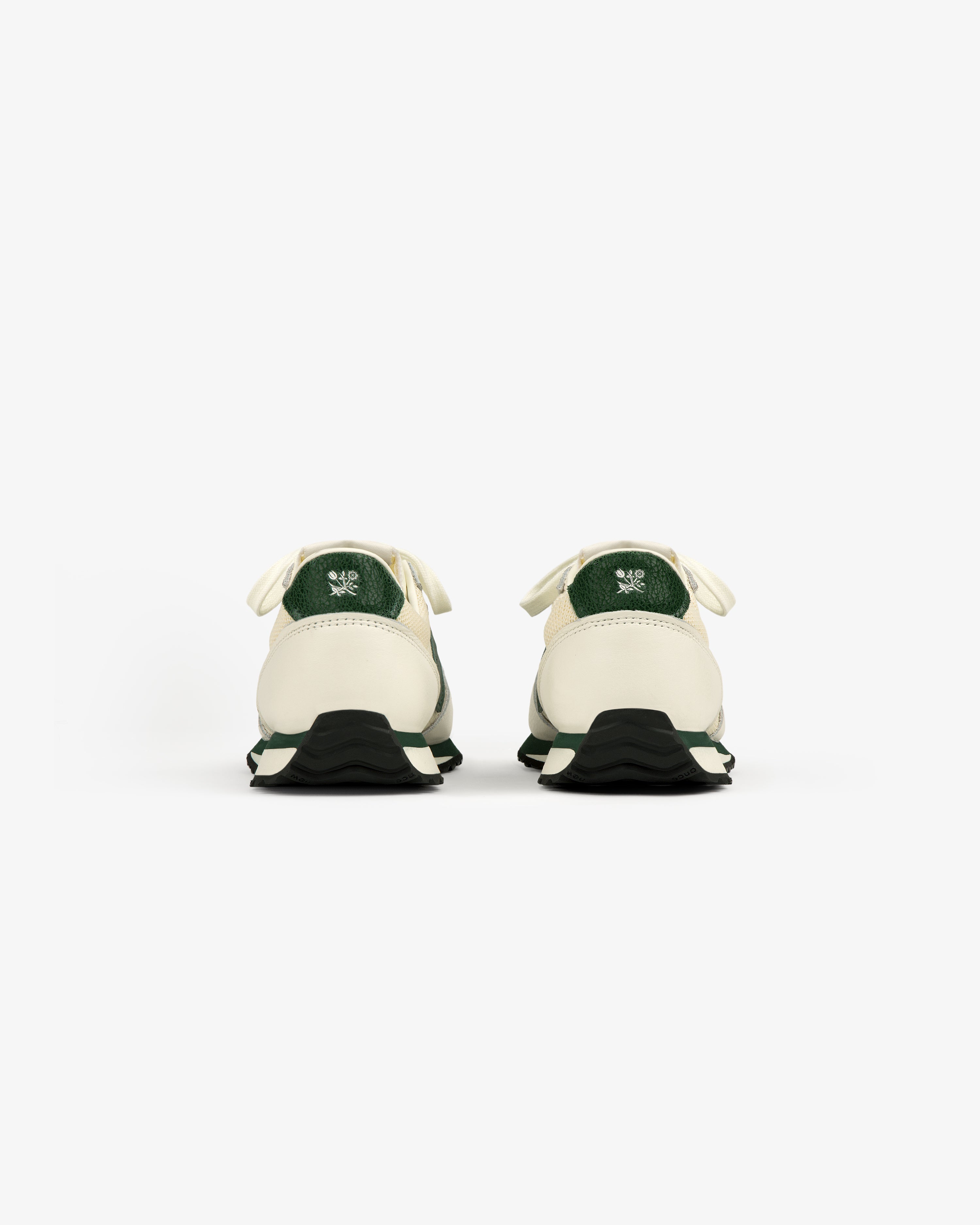 ALD / New Balance 471 sneakers in white and green, viewed from the back on a white background.