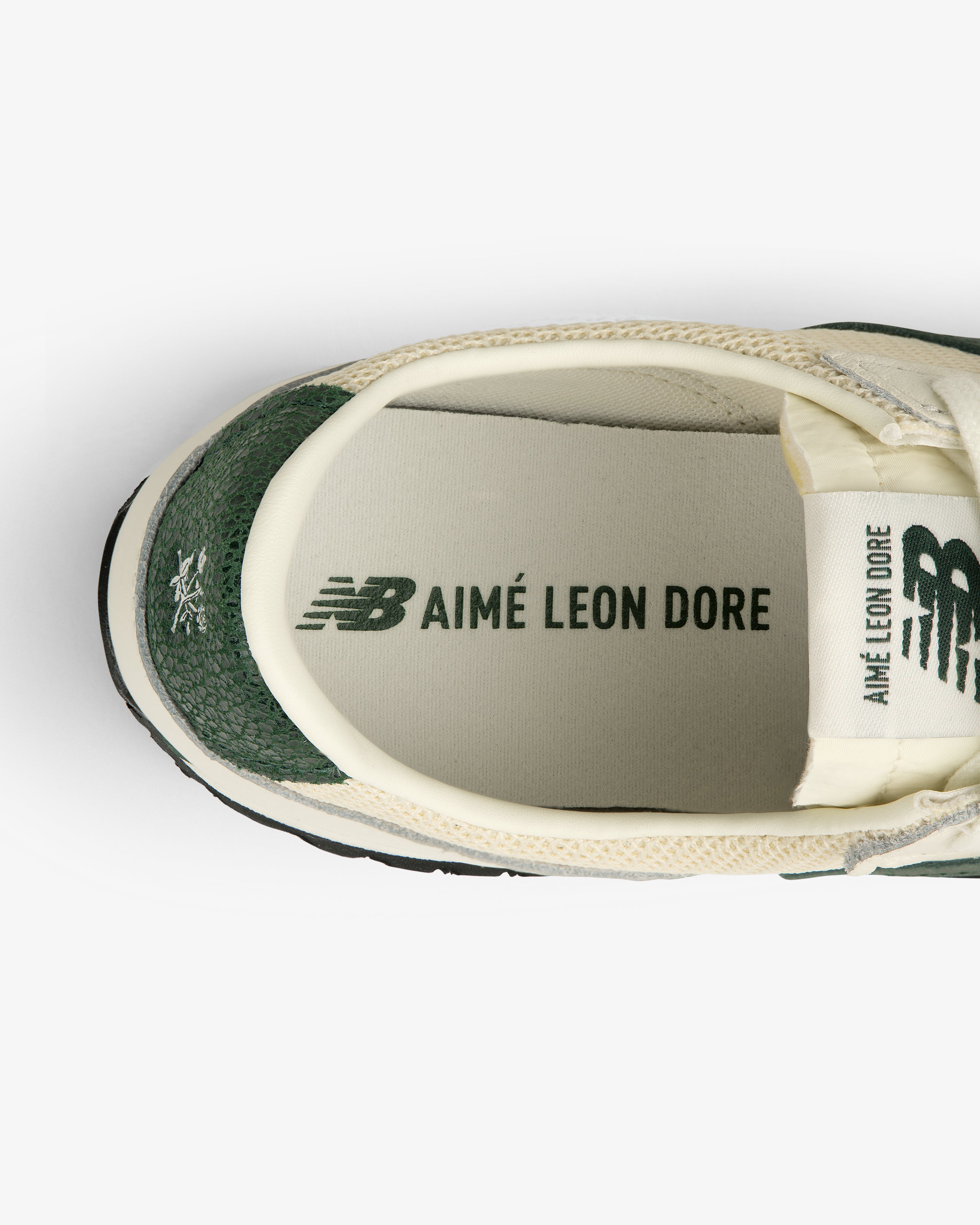 Top view of the ALD / New Balance 471 sneaker in green and cream, logo visible on insole and tongue.
