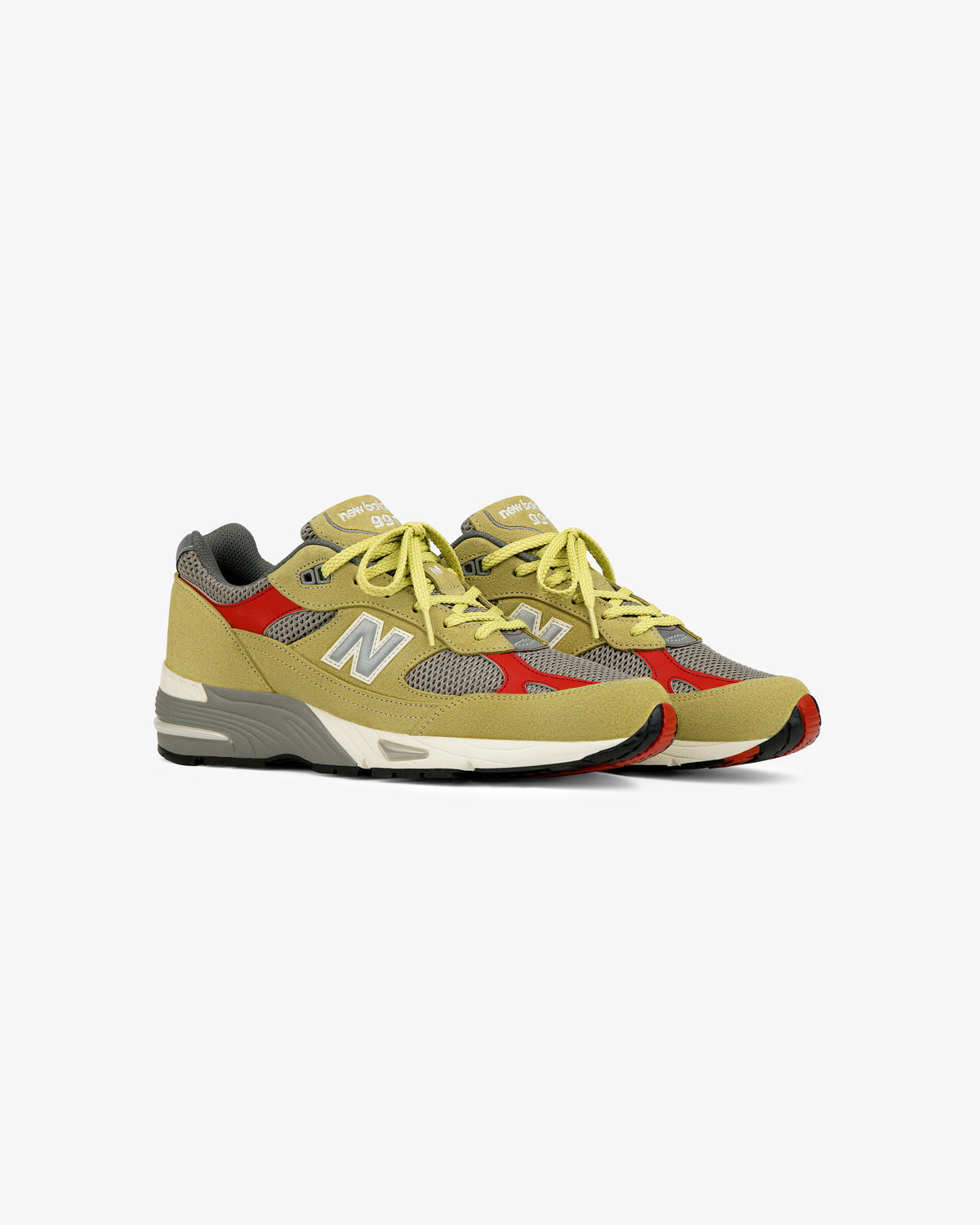 A pair of ALD / New Balance Made in UK 991 sneakers in yellow and gray mesh and suede, on a white background.