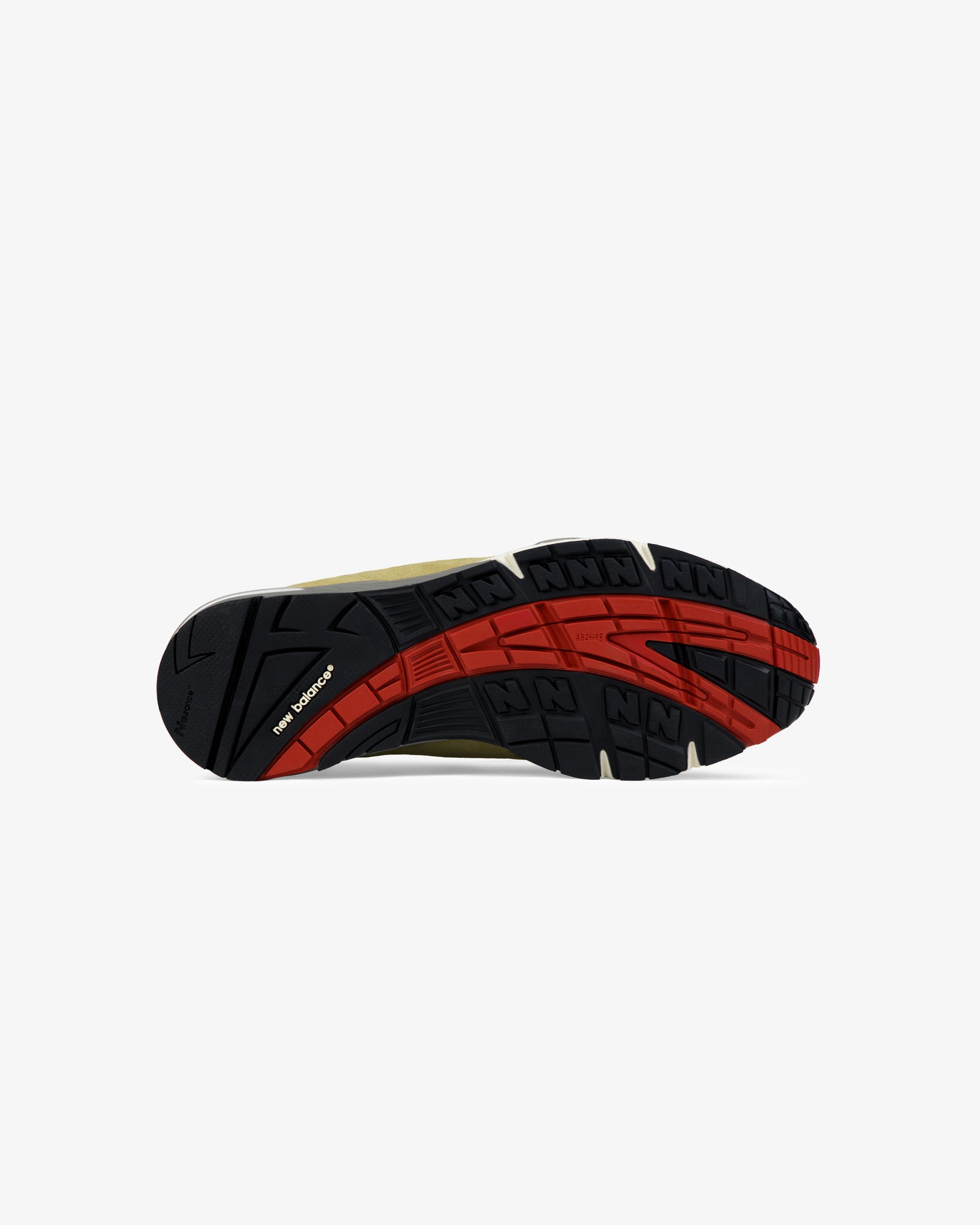 ALD / New Balance Made in UK 991 black and red rubber sole with textured tread, viewed from the bottom on white.