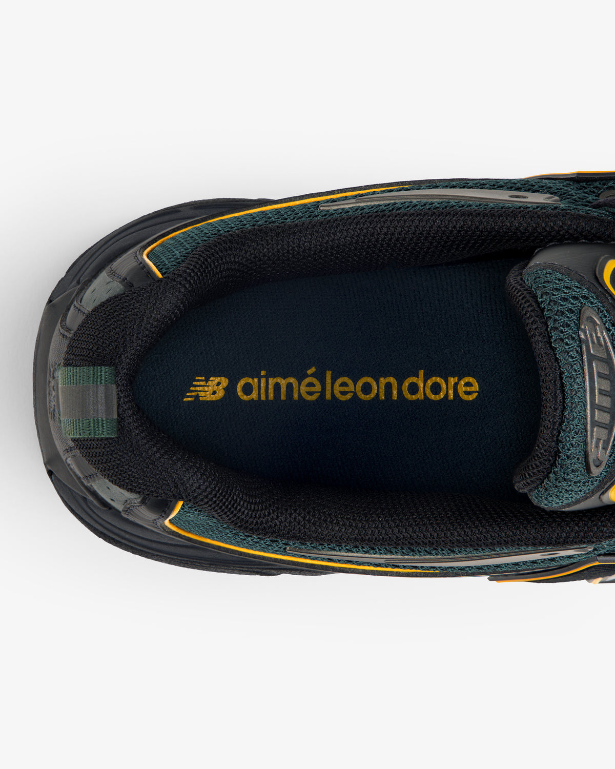 Top view of the ALD / New Balance RC56 black sneaker with yellow aimé leon dore and NB logos on the insole.