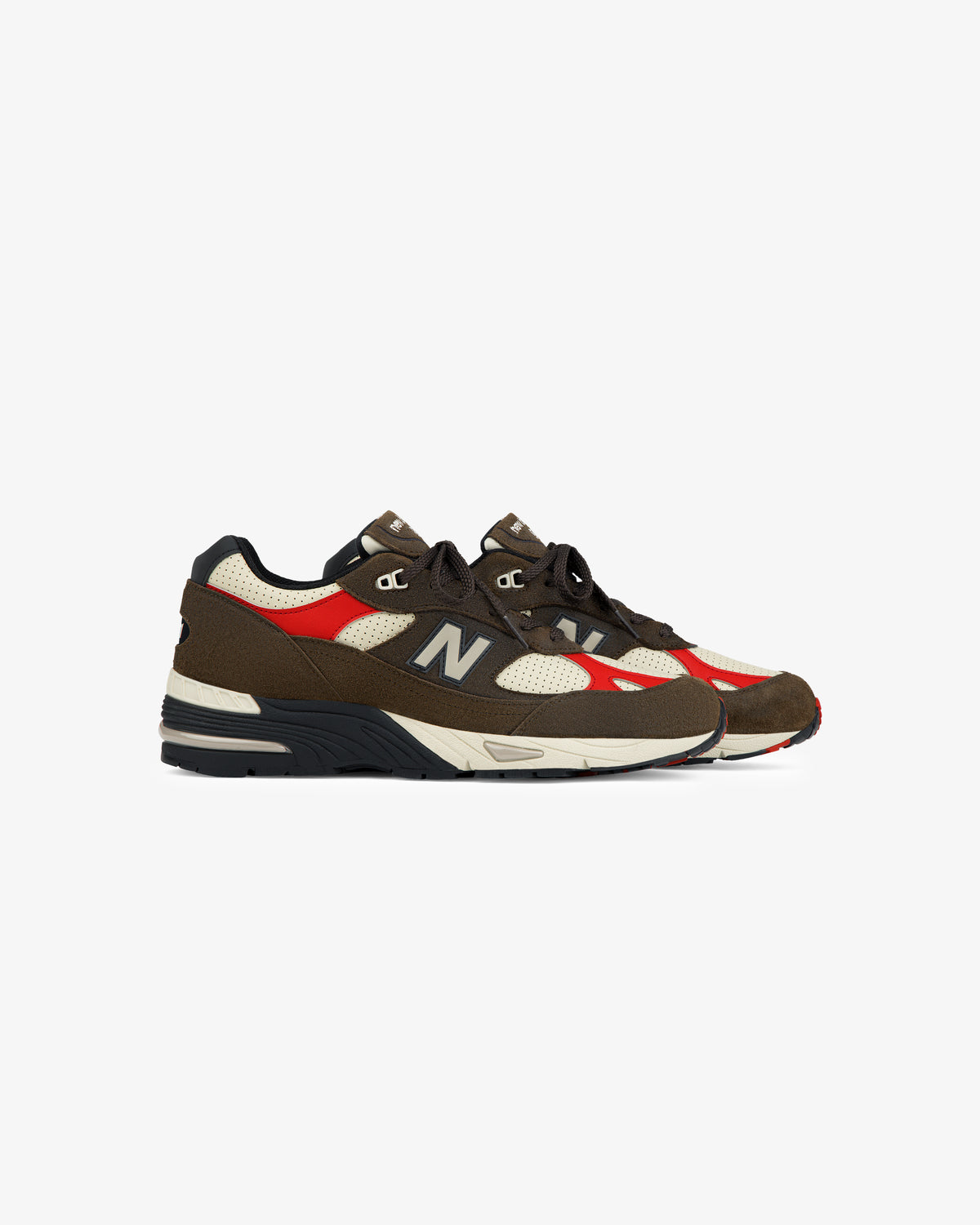 A pair of ALD / New Balance Made in UK 991 sneakers with brown, red, beige, and black accents on a white background.
