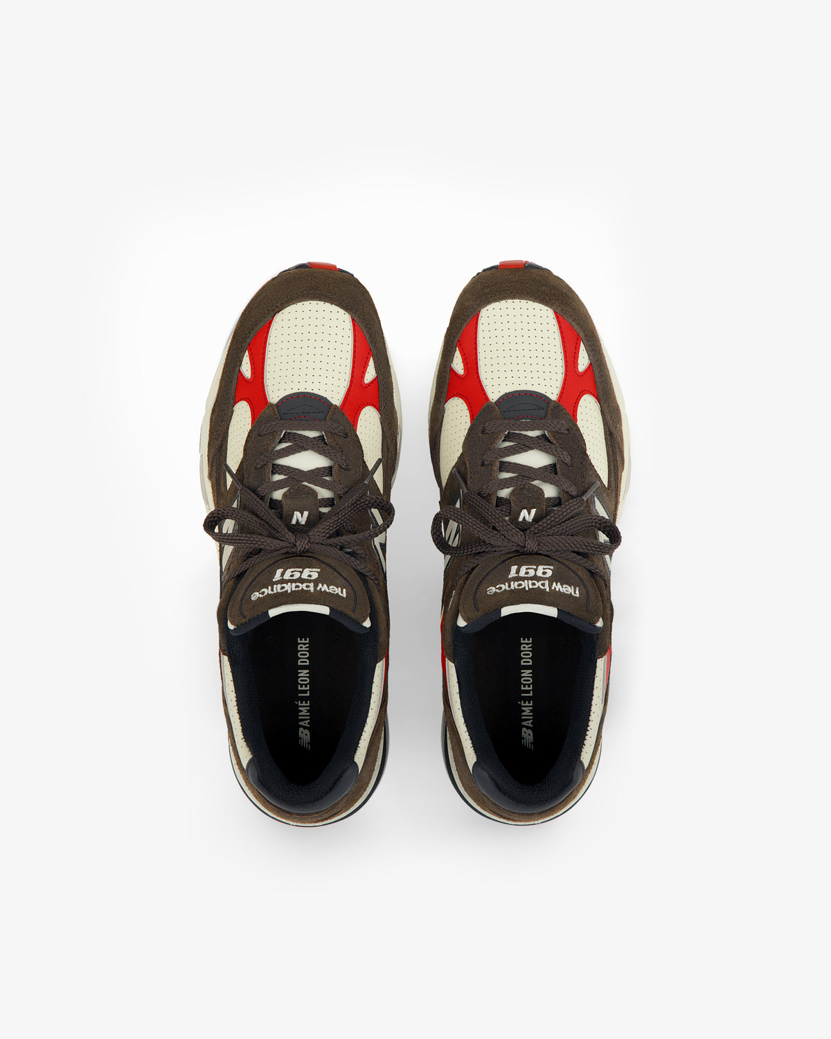 A pair of brown, cream, and red ALD / New Balance Made in UK 991 sneakers viewed from above on a white background.