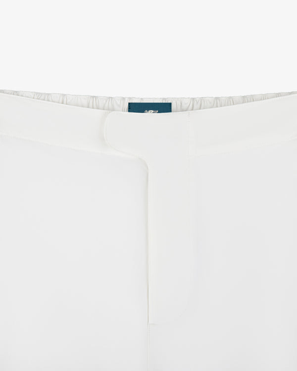 Close-up of the waistband and front closure of ALD / New Balance RC56 Performance Nylon Trouser in white.