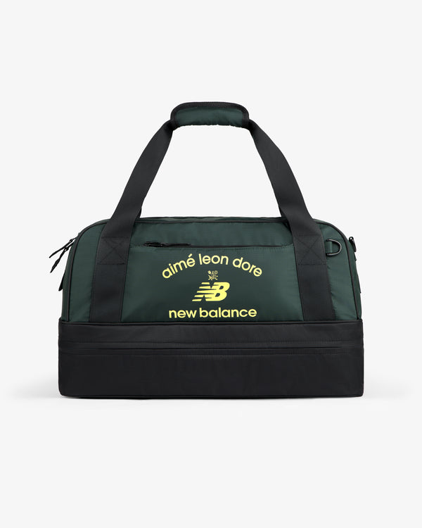 ALD / New Balance Travel Duffle Bag in dark green and black with yellow logos on the front.