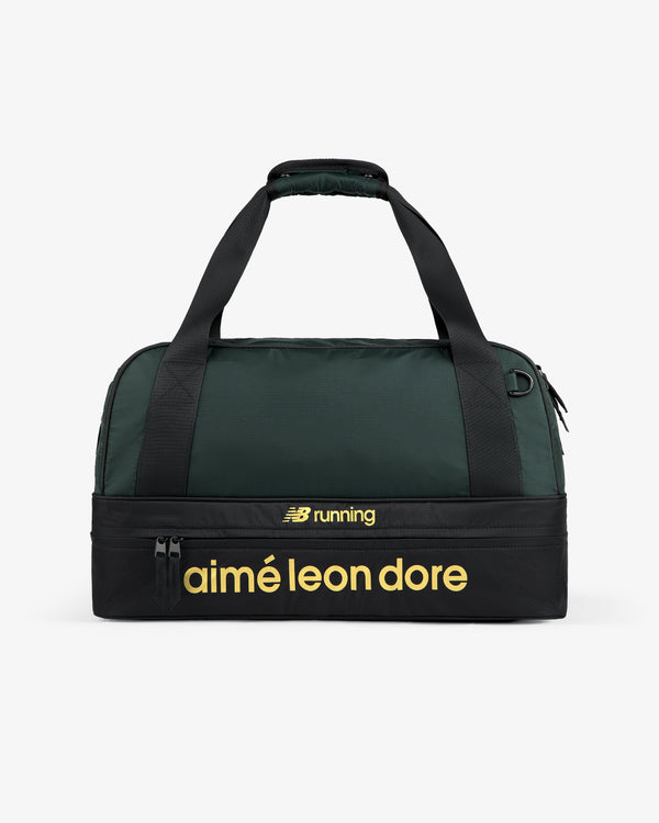 A green and black ALD / New Balance Travel Duffle Bag with yellow “aimé leon dore” and “NB running” on the front.