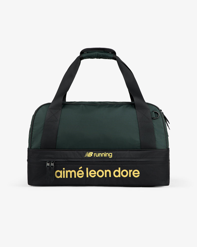 A green and black ALD / New Balance Travel Duffle Bag with yellow “aimé leon dore” and “NB running” on the front.