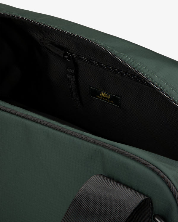 Close-up of ALD / New Balance Travel Duffle Bag open, showing black zippered inner pocket and inside label.