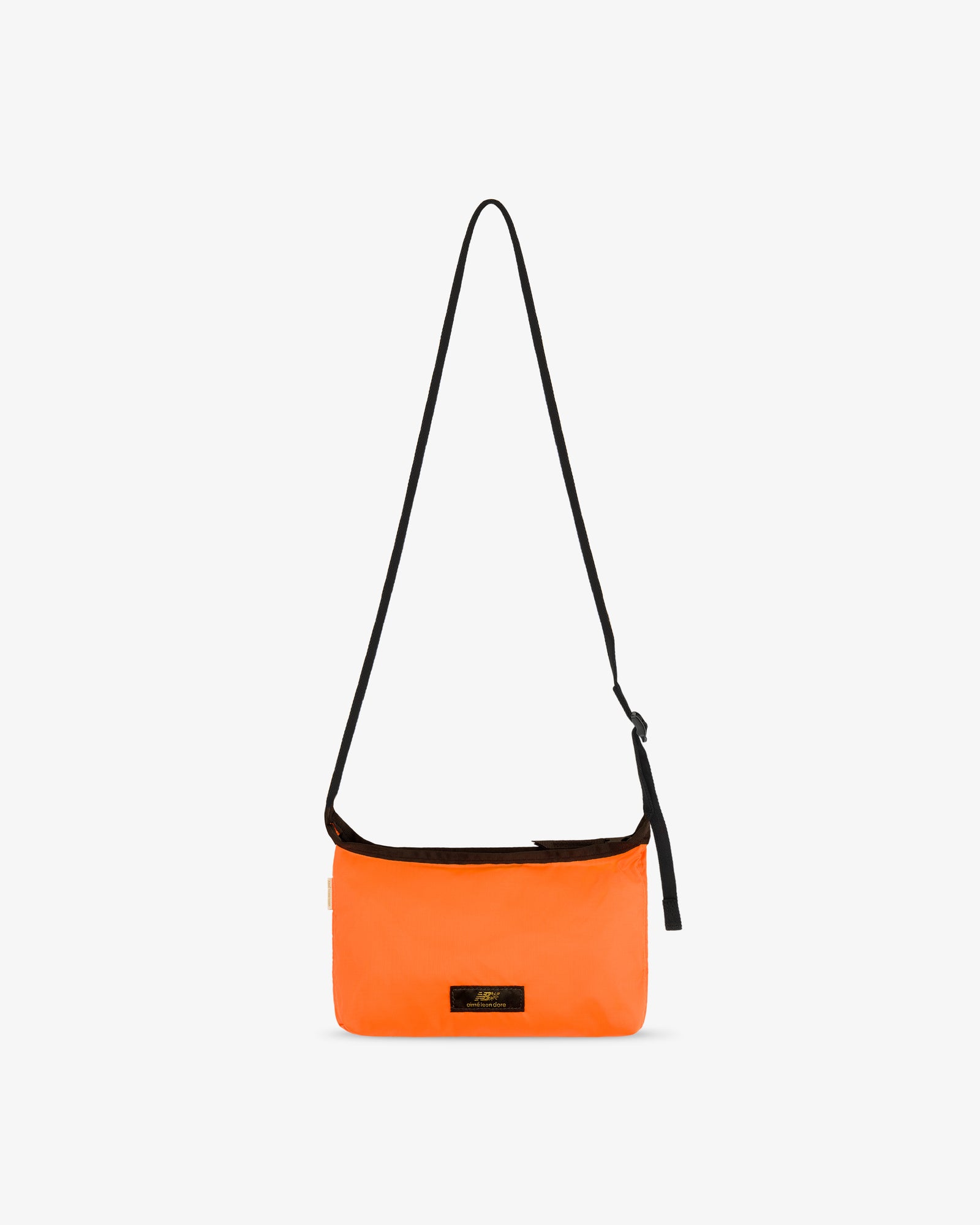 ALD / New Balance Nylon Sling Pouch: bright orange, long black strap, small black front label on white background.