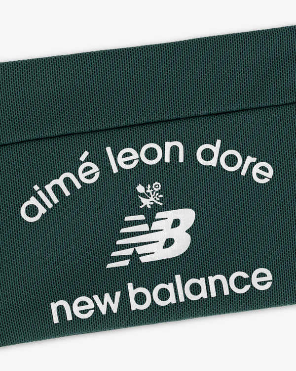 Dark green ALD / New Balance Performance Running Belt with white logo and text on textured surface.