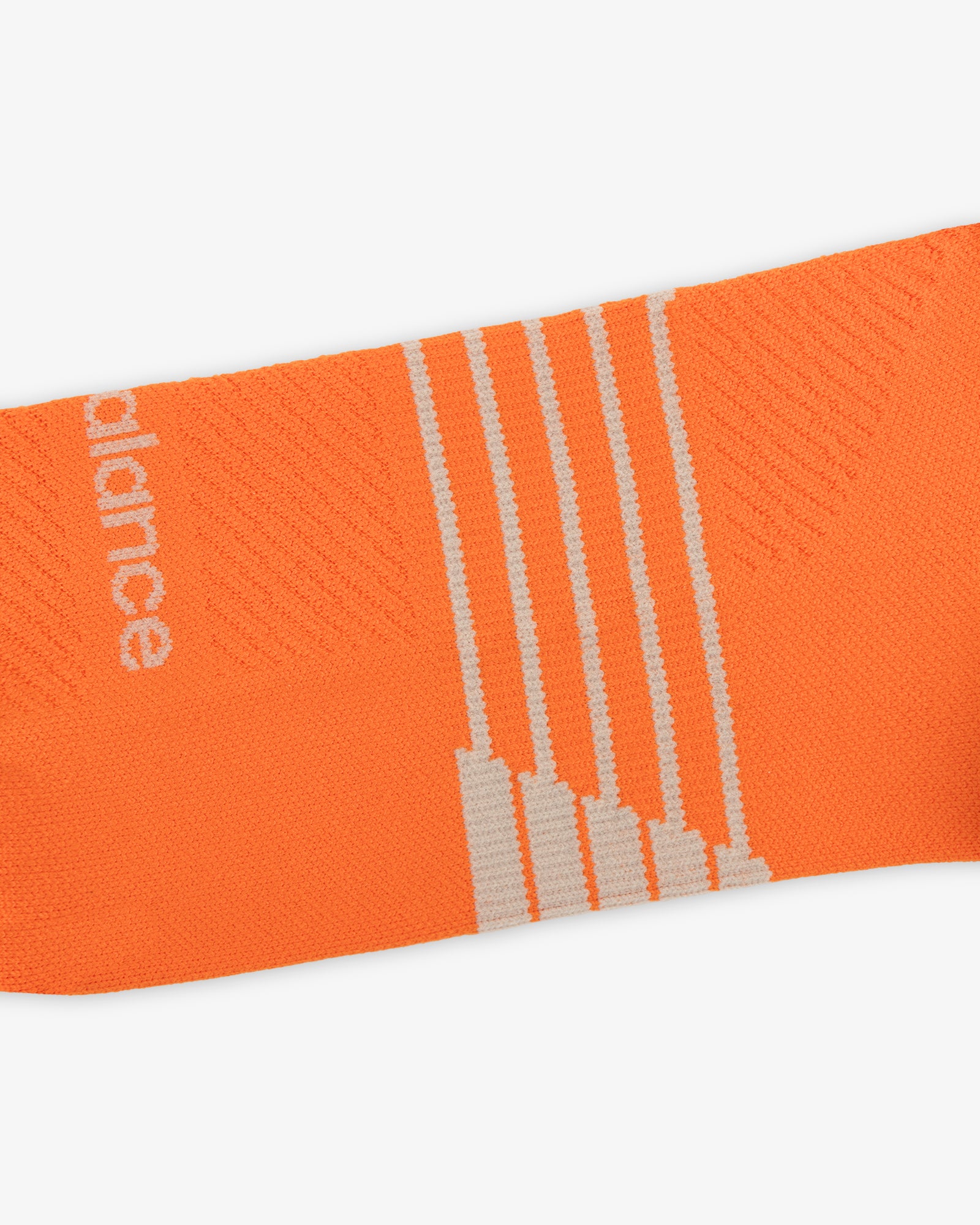 Close-up of ALD / New Balance Running Crew Sock—orange with white stripes and partial white text on the side.