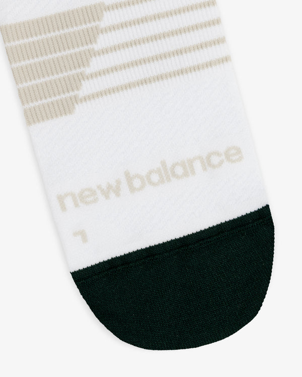 ALD / New Balance Running Crew Sock in white with beige stripes, black toe, and logo near the toe.