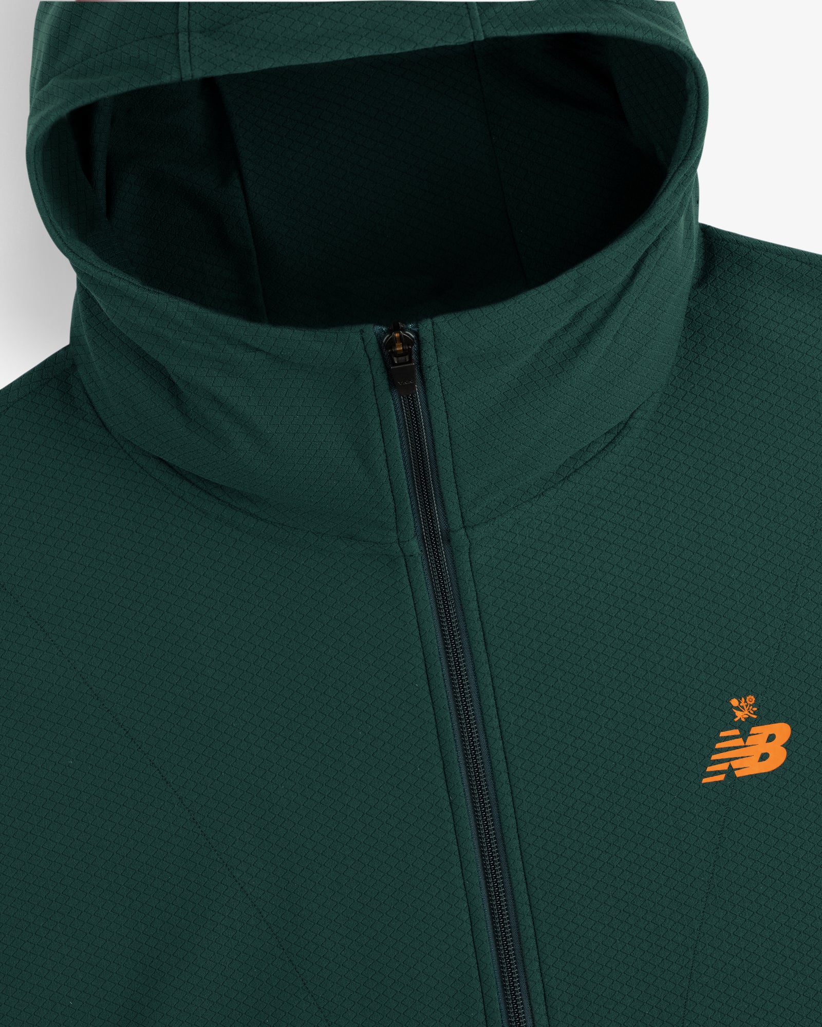 Dark green ALD / New Balance Full-Zip Warmup Hoodie with an orange logo, shown from the shoulders up.