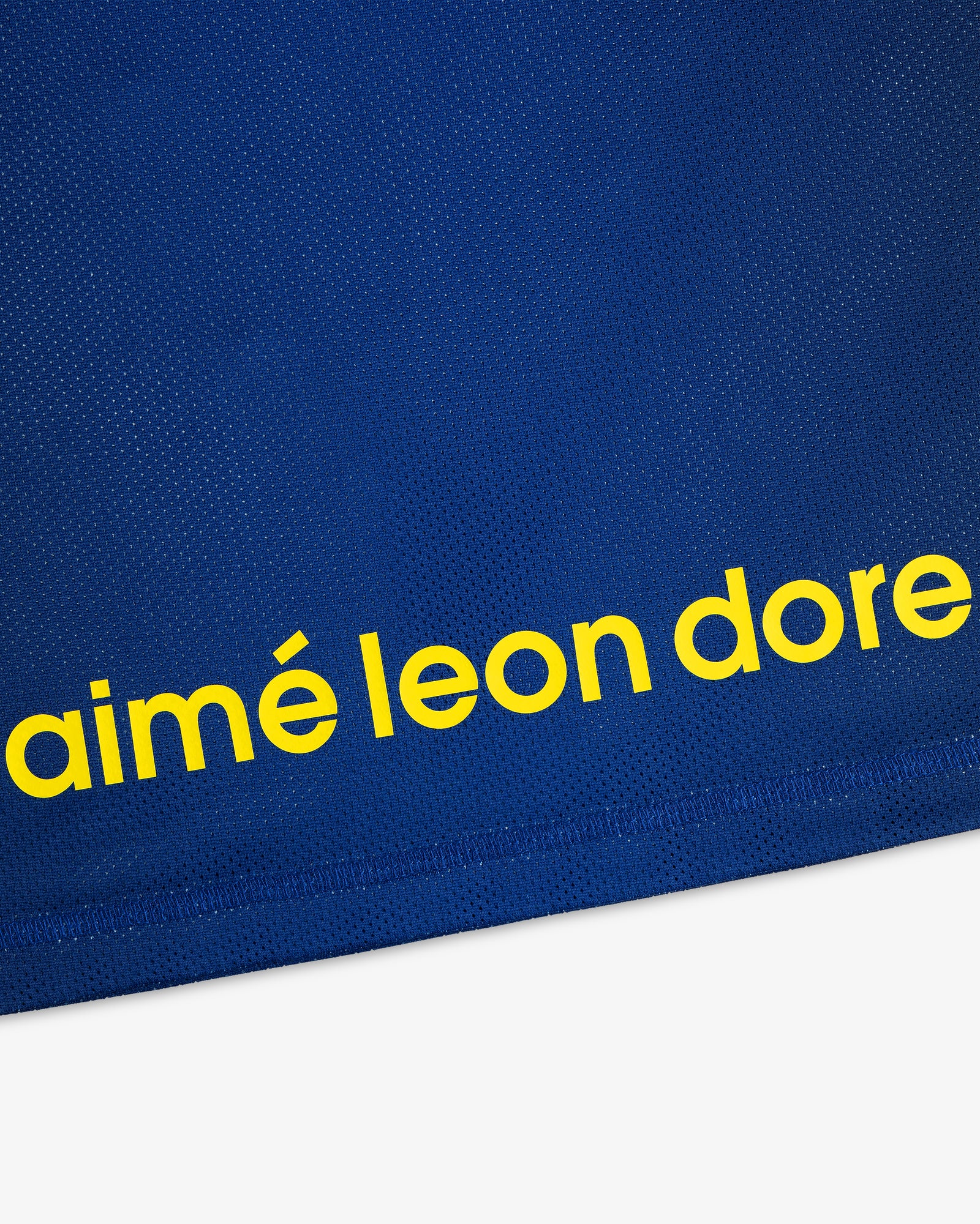 Blue ALD / New Balance Running Gradient Singlet with bold yellow “aimé leon dore” text near the hem.