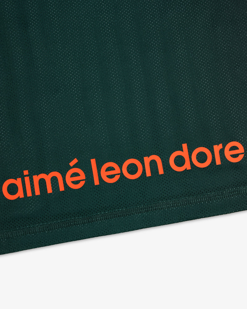 Close-up of dark green ALD / New Balance Running Gradient Singlet with bold orange aimé leon dore near the edge.