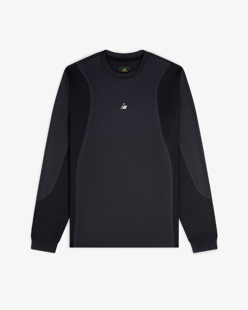 ALD / New Balance Performance Long-Sleeve Tee in black with subtle panels and white chest logo, shown on white background.