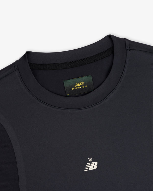 Close-up of a black ALD / New Balance Performance Long-Sleeve Tee with white logo and green label inside the collar.