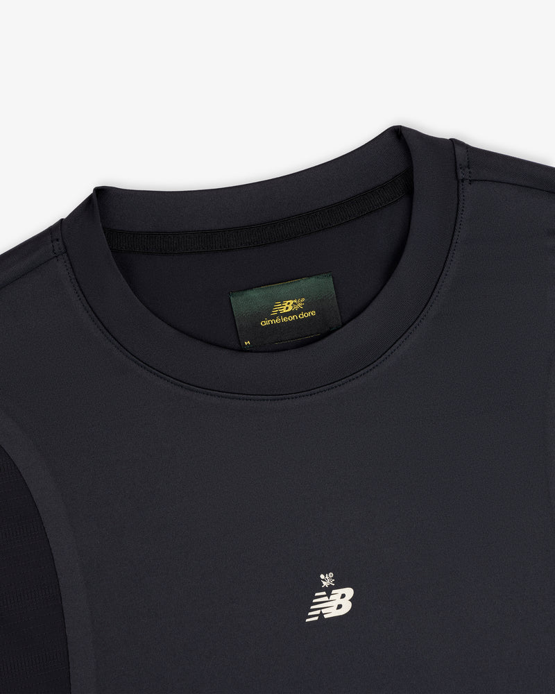 Close-up of a black ALD / New Balance Performance Long-Sleeve Tee with white logo and green label inside the collar.
