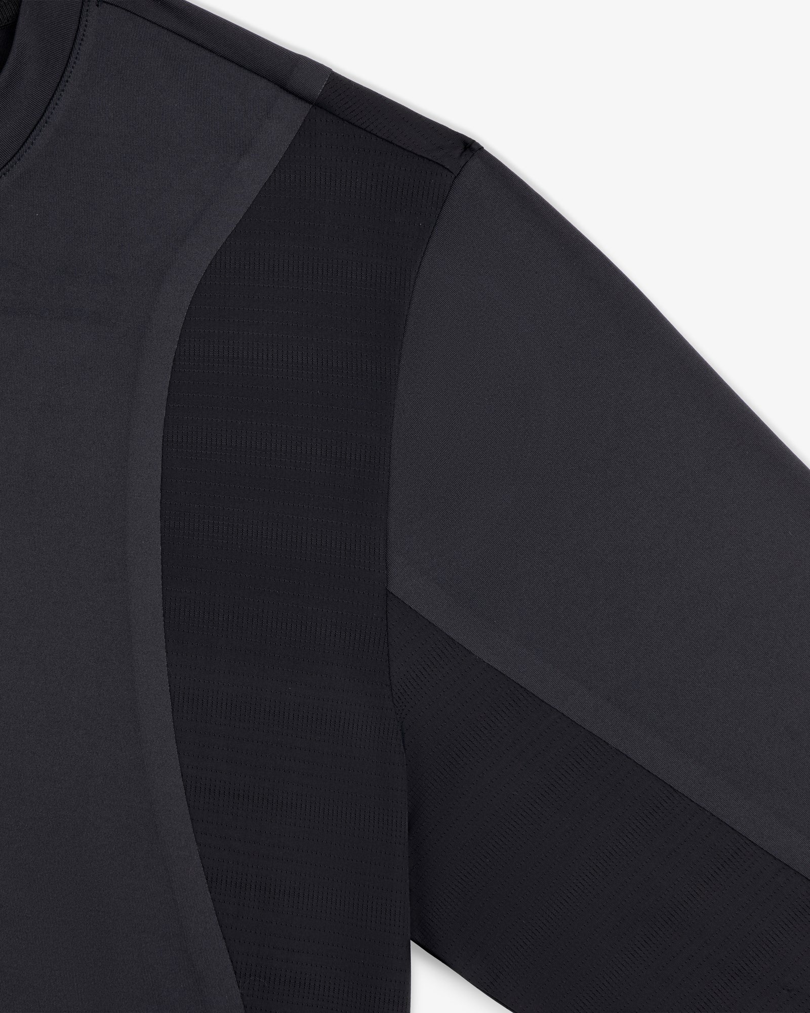 Close-up of ALD / New Balance Performance Long-Sleeve Tee showing fabric texture and seam details on shoulder and sleeve.