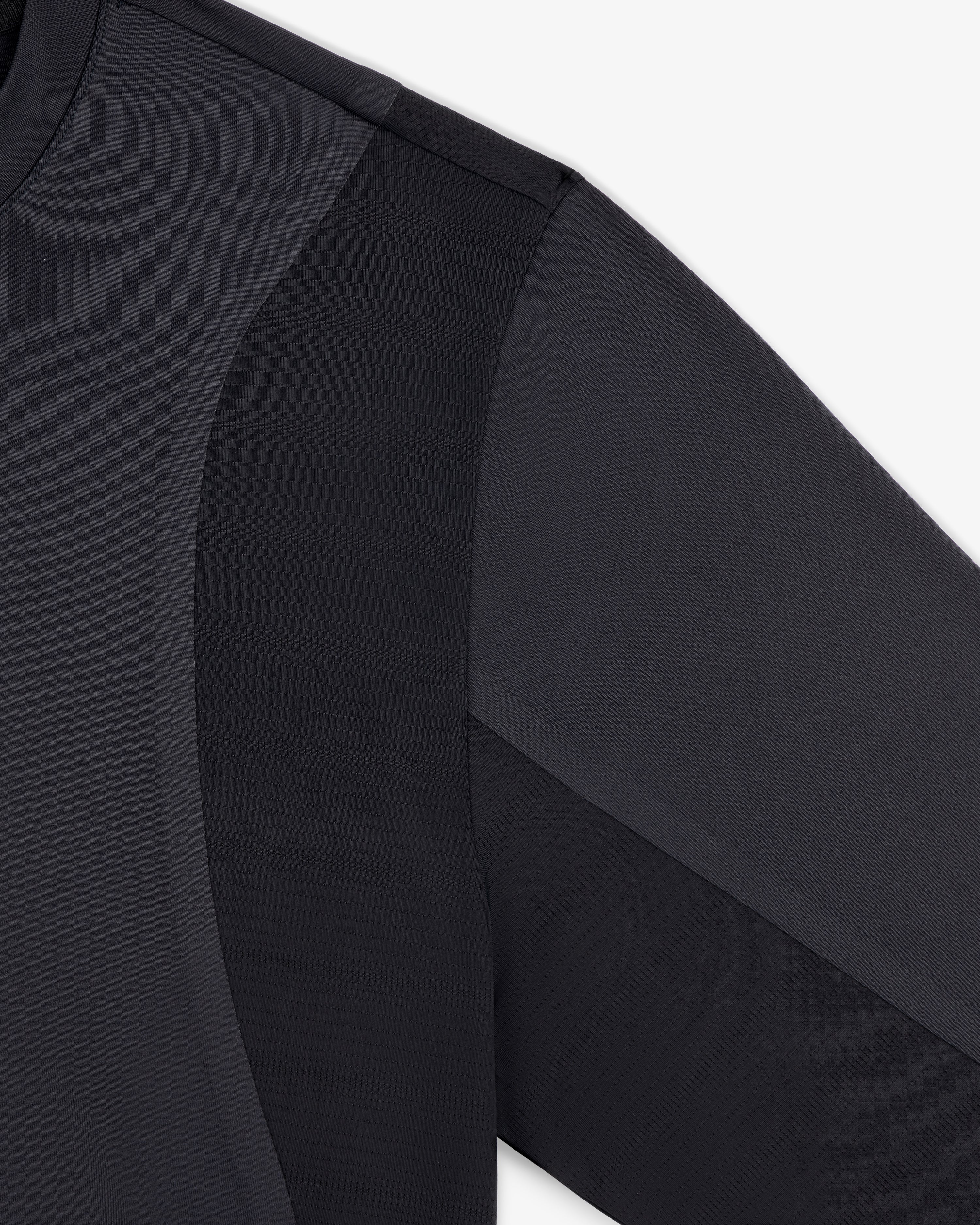 Close-up of ALD / New Balance Performance Long-Sleeve Tee showing fabric texture and seam details on shoulder and sleeve.