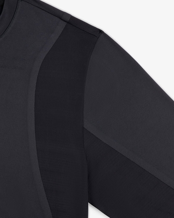 Close-up of ALD / New Balance Performance Long-Sleeve Tee showing fabric texture and seam details on shoulder and sleeve.