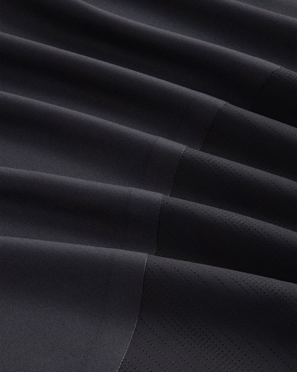 Close-up of the ALD / New Balance Performance Long-Sleeve Tee's dark, pleated fabric with matte and shiny textures.