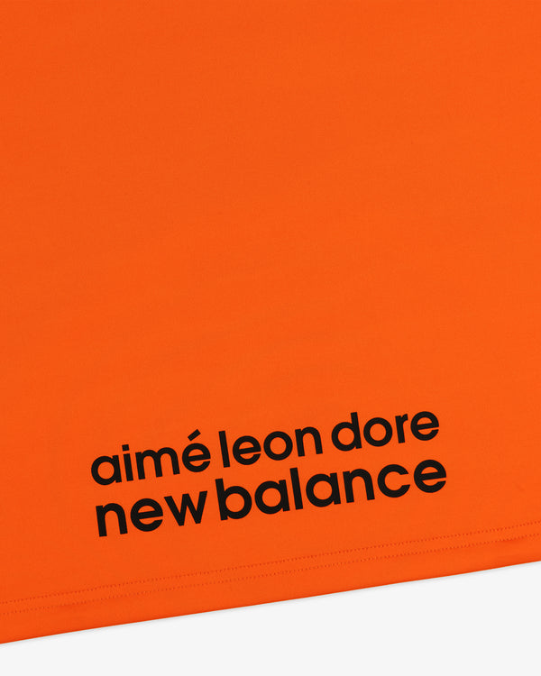 Bright orange ALD / New Balance Performance Long-Sleeve Tee with bold black logo near the bottom edge.