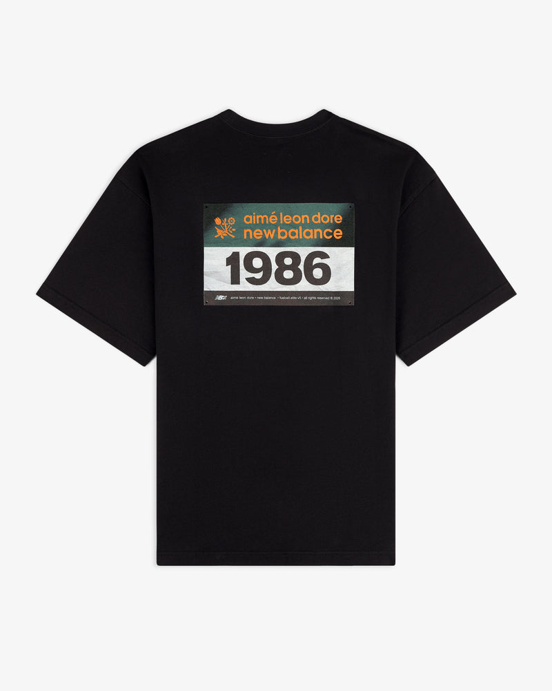 ALD / New Balance Running Bib Tee features a black color and racing bib graphic printed on the back.