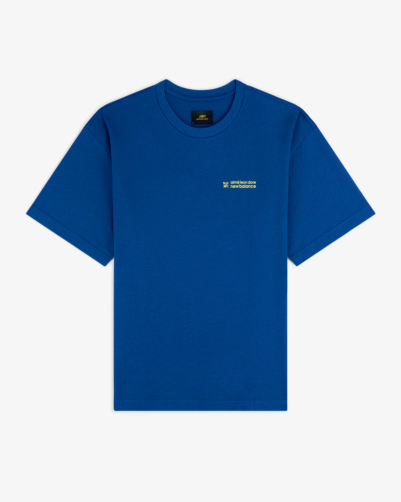 ALD / New Balance Running Bib Tee in blue with small yellow-green chest text, displayed flat on a white background.