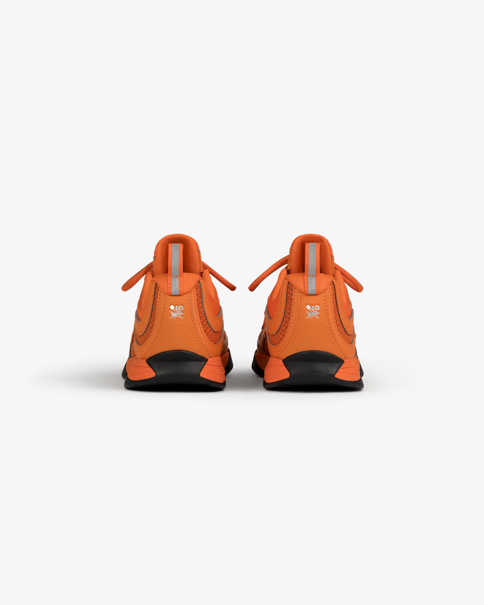 ALD / New Balance RC56 orange sneakers shown from the back on a white background.