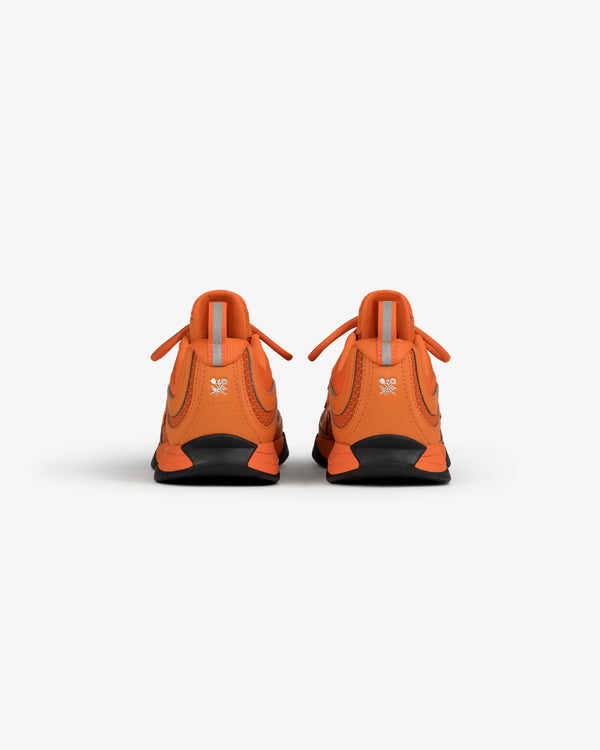 ALD / New Balance RC56 orange sneakers shown from the back on a white background.