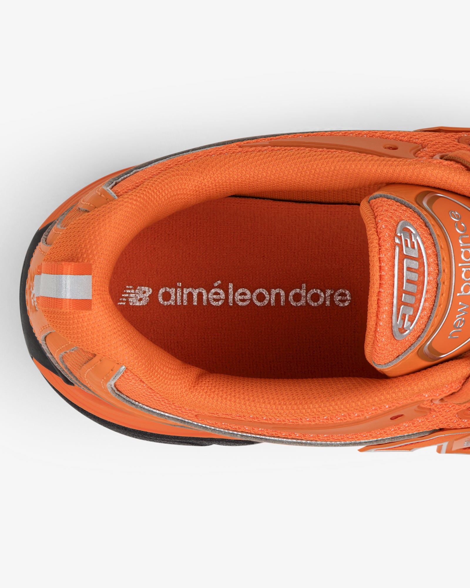 Top view of orange ALD / New Balance RC56 with logos on the insole.