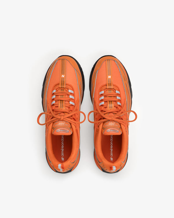 ALD / New Balance RC56 orange sneakers viewed from above on a white background.