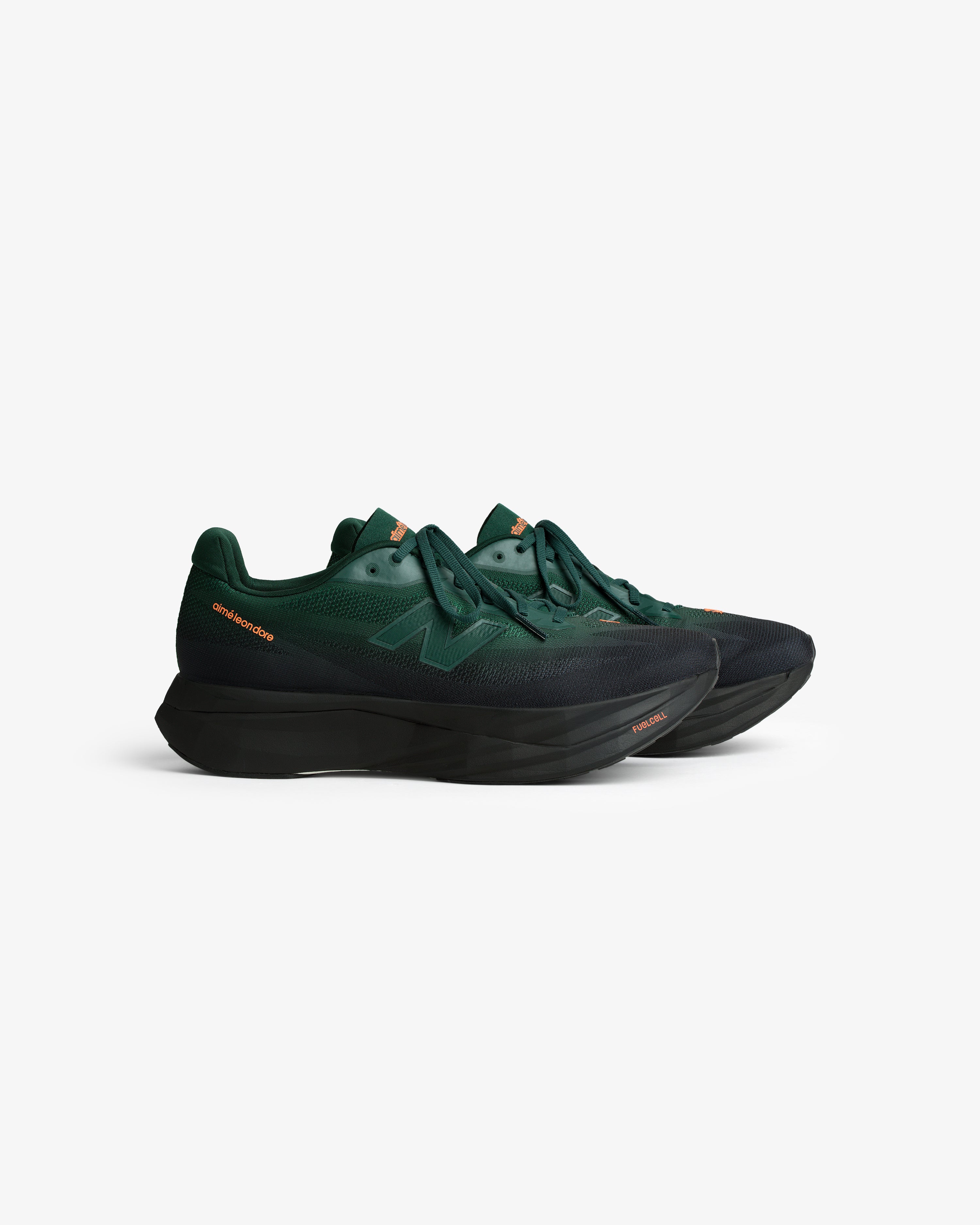 ALD / New Balance FuelCell SuperComp Elite v5 in dark green with black soles and orange accents on white background.