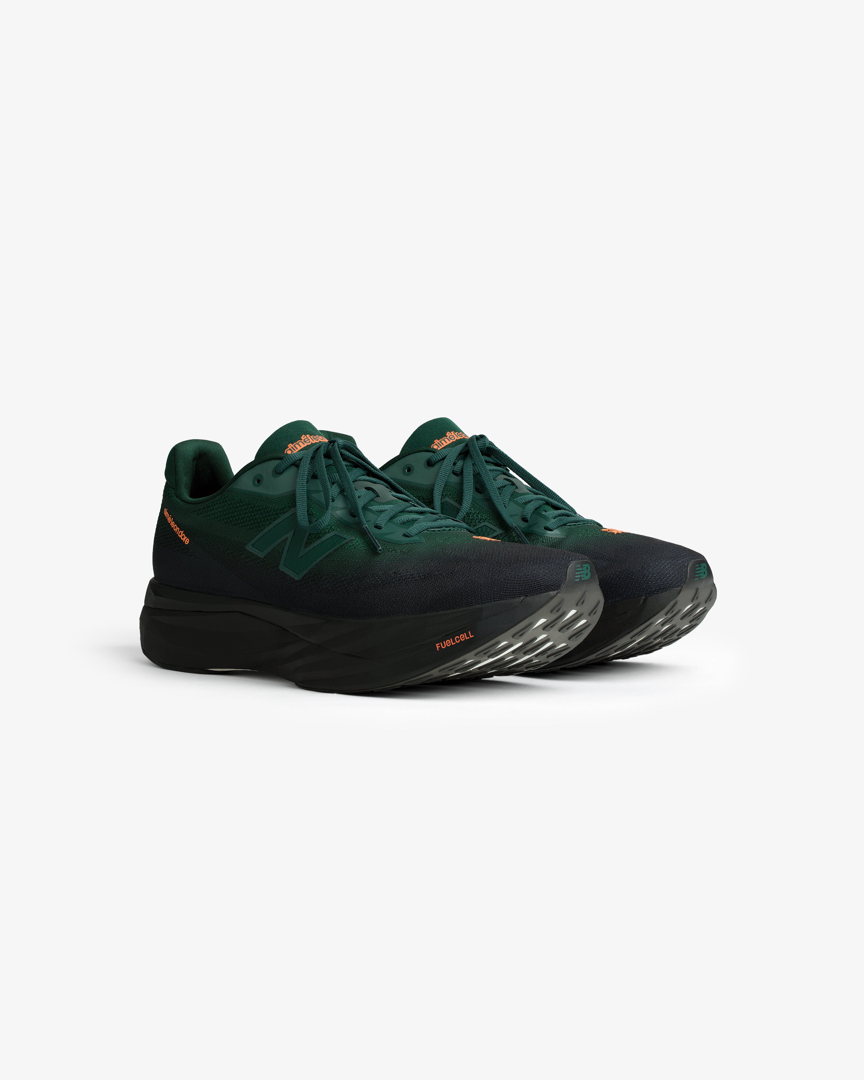 ALD/New Balance FuelCell SuperComp Elite v5 in dark green with black soles and orange accents on a white background.
