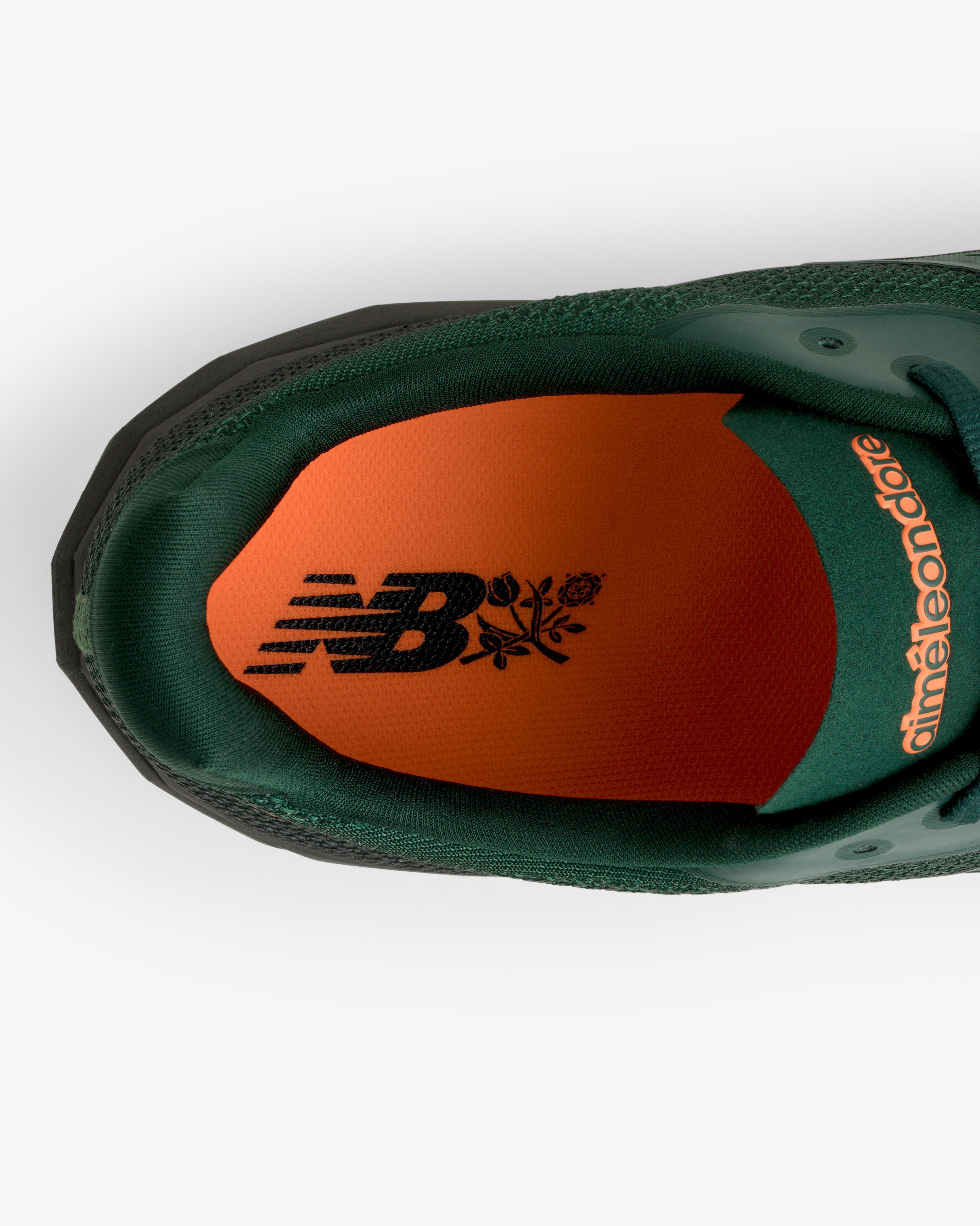 Top view of ALD / New Balance FuelCell SuperComp Elite v5: green sneaker, orange insole, black logos.