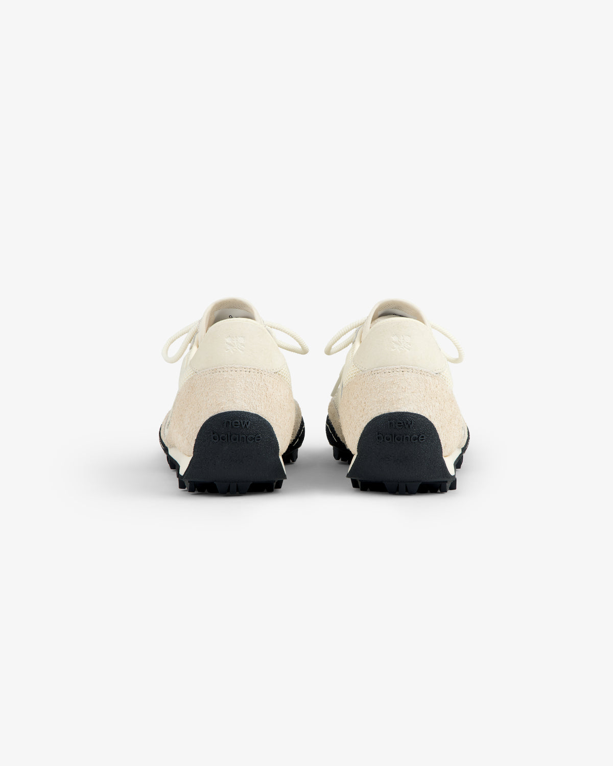 A pair of ALD / New Balance Gator sneakers in off-white, shown from the back against a white background.