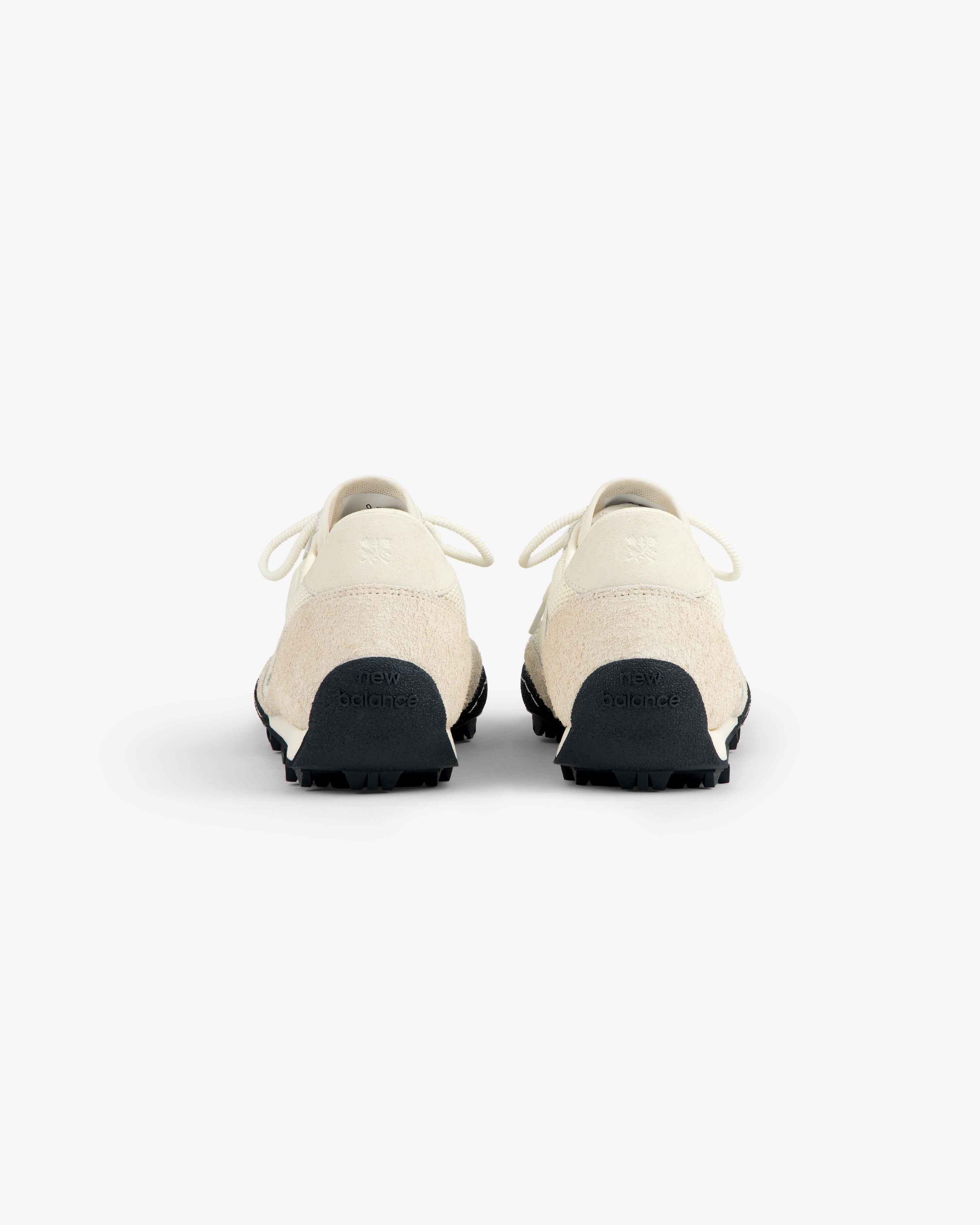 A pair of ALD / New Balance Gator sneakers in off-white, shown from the back against a white background.