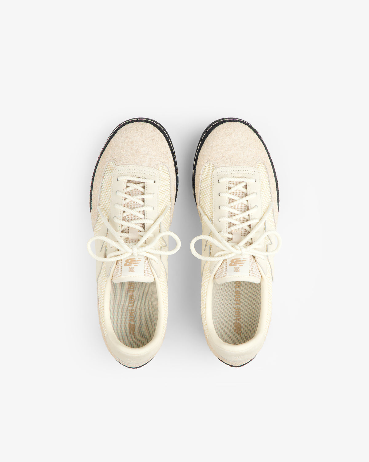 Top view of ALD / New Balance Gator cream lace-up sneakers with beige accents on a white background.