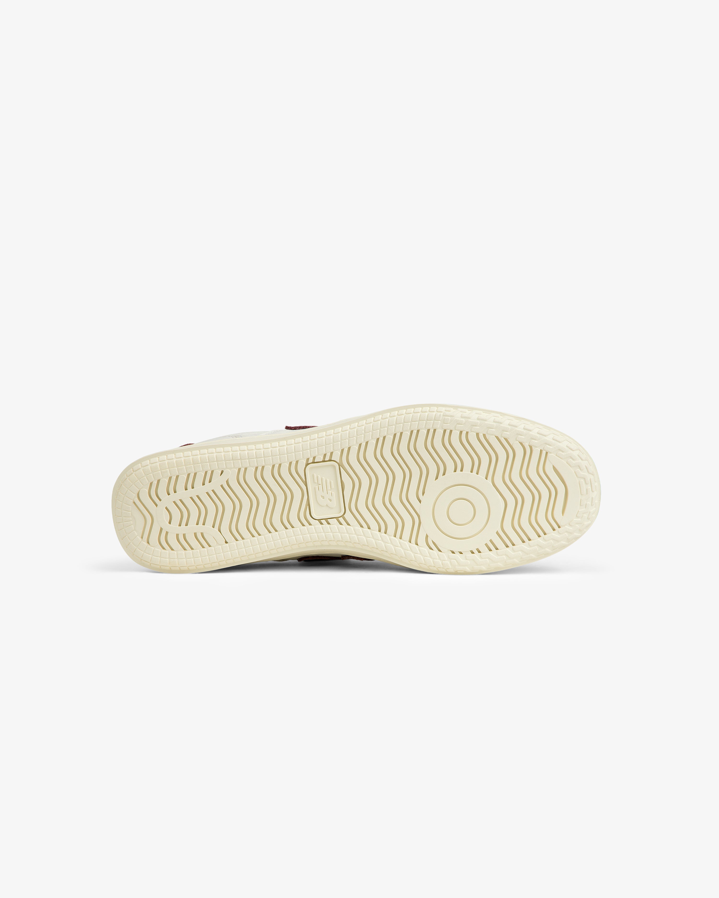 Cream-colored ALD / New Balance T500 Tennis Oxfords outsole with a wavy tread pattern and a circular pivot point.