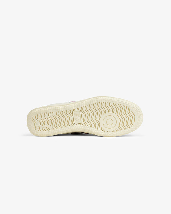 Cream-colored ALD / New Balance T500 Tennis Oxfords outsole with a wavy tread pattern and a circular pivot point.